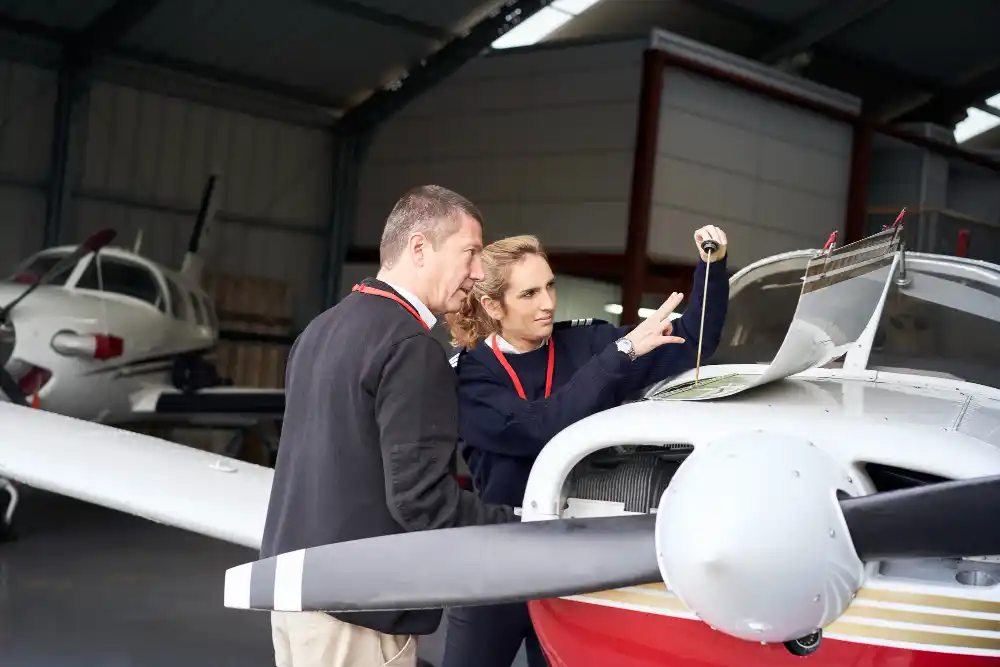 Flight instructor teaching a student how to carry out aircraft maintenance
