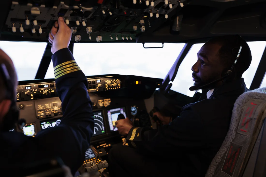 Pakistani commercial pilot conducting pre-flight checks in an aircraft cockpit