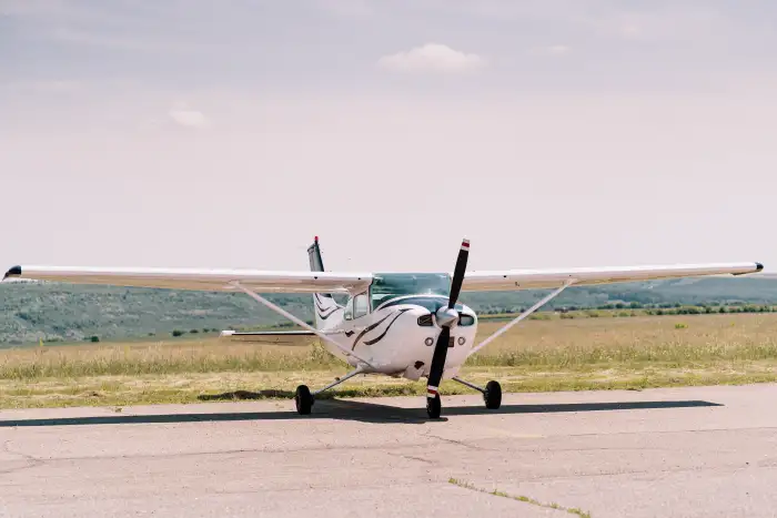 South Asian flight training student walking toward a Cessna training aircraft on the runway