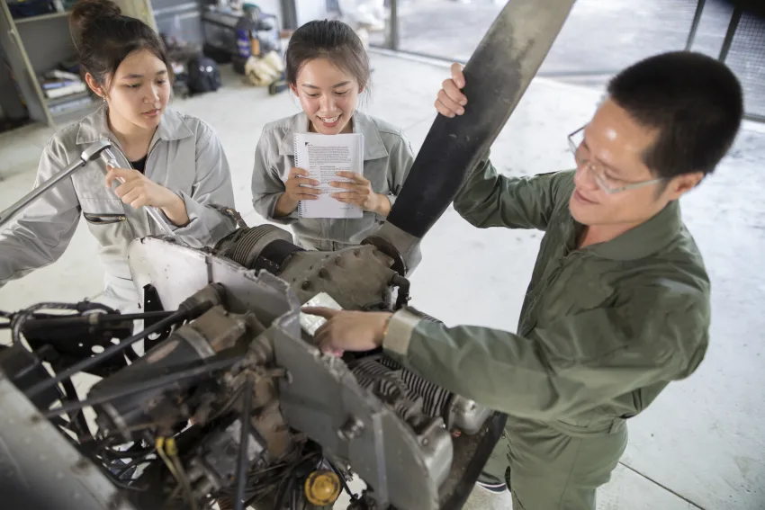 Aircraft maintenance engineers and technicians working together to repair an airplane