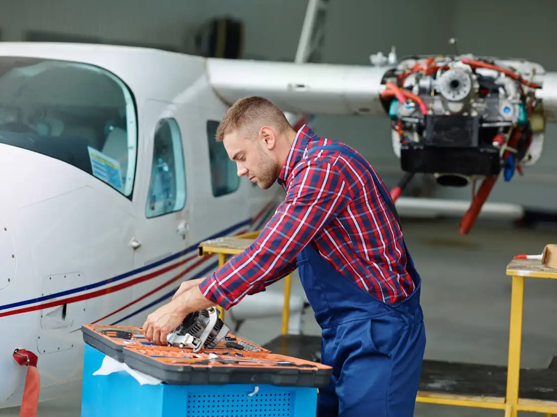 Aircraft maintenance engineer tightening an engine fastener with a torque wrench