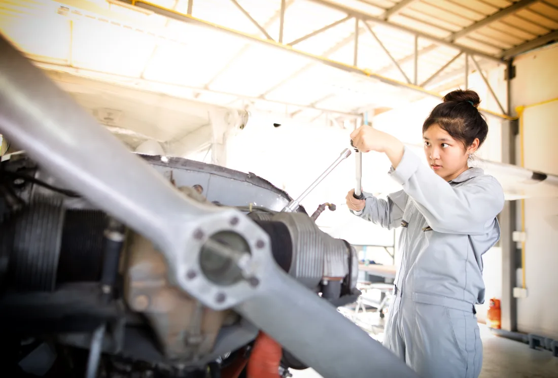 Pakistani AME engineer wearing a headset during a fast aircraft turnaround on the ramp