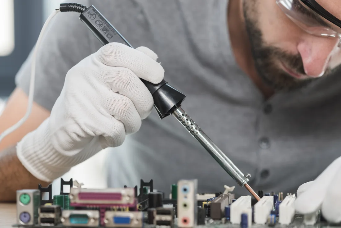 Close-up of soldering an electronic circuit board, a core skill for aircraft avionics and electrical work