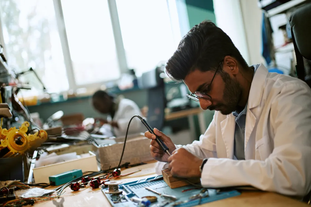 Engineer soldering an electronic component in a laboratory, the practical side of the electrical and electronic fundamentals modules