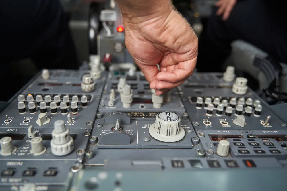 Hand adjusting switches on an aircraft cockpit control panel, the avionics systems studied in Module 13 for Category B2