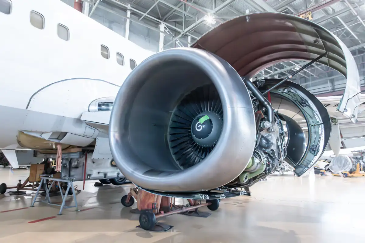 Open turbofan engine of a passenger aircraft in a hangar, representing the Part-66 modules for aircraft maintenance engineers