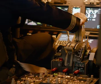 Aviation crew flying airplane with engine lever to throttle, using dashboard command buttons to takeoff. Control panel navigantion and windscreen to fly plane, using power handle. Close up.