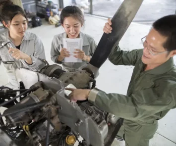 Aircraft maintenance engineers and technicians working together to repair an airplane