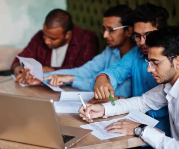South Asian aviation professionals reviewing and signing aircraft maintenance license documents