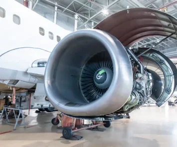 Open turbofan engine of a passenger aircraft in a hangar, representing the Part-66 modules for aircraft maintenance engineers
